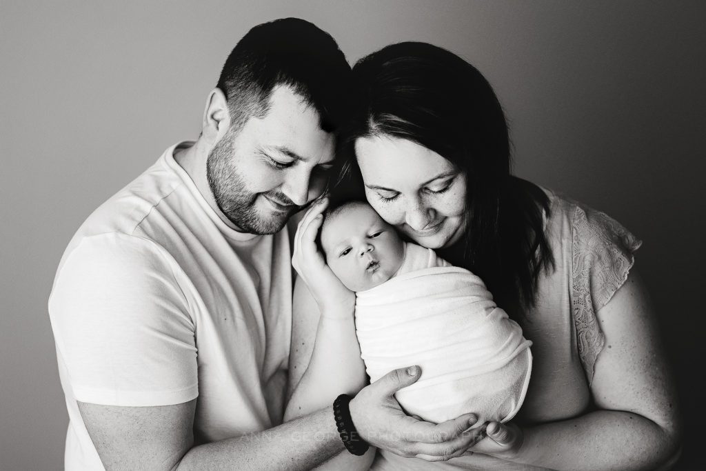 portrait of newborn baby with family