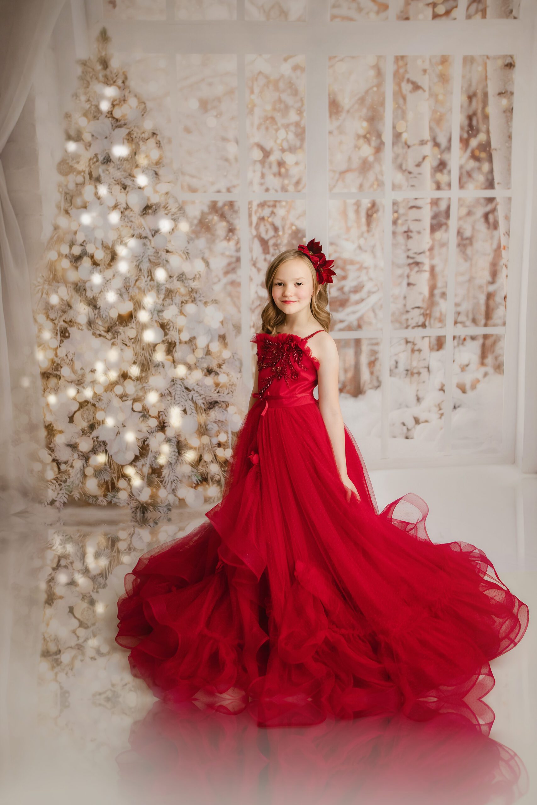 girl in glamorous red dress by white christmas tree studio photo session in madison wi